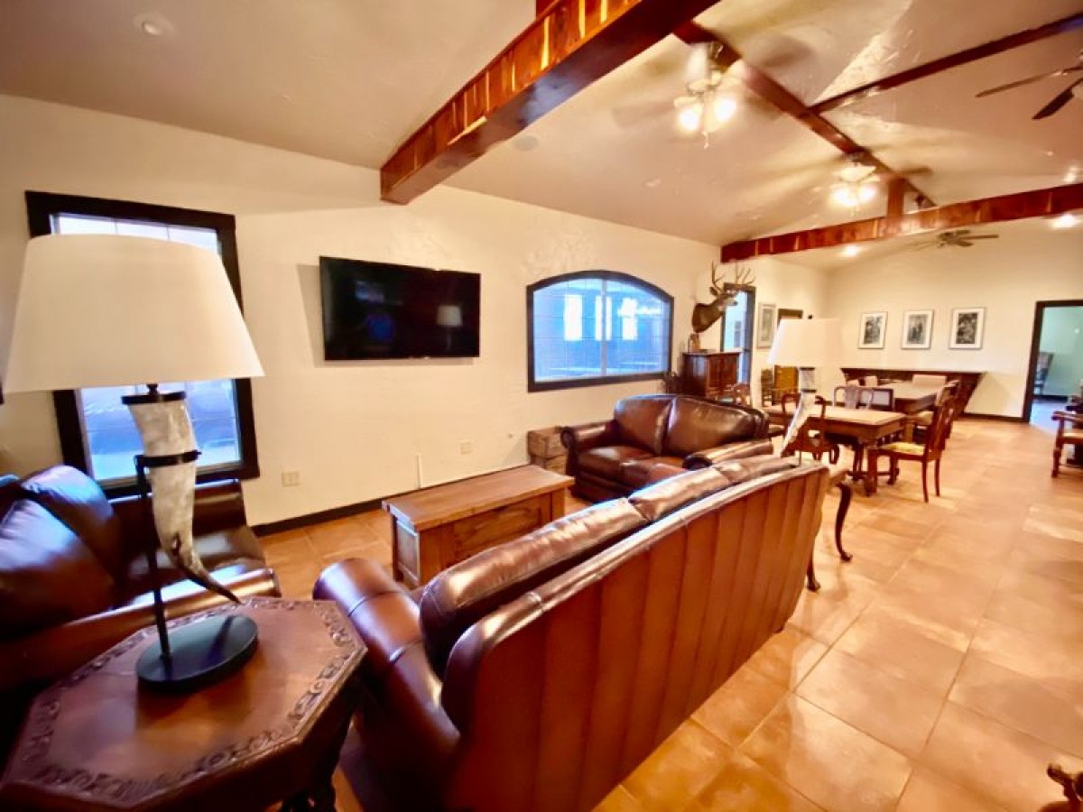 Seating area with couches, and a tv on the wall