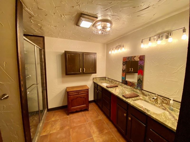 bathroom with two sinks and large walk-in shower