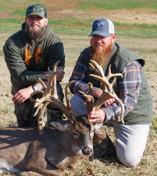 Two men holding up trophy whitetail deer in Texas