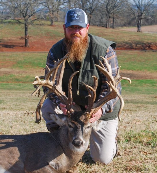 Hunter holding trophy whitetail buck deer