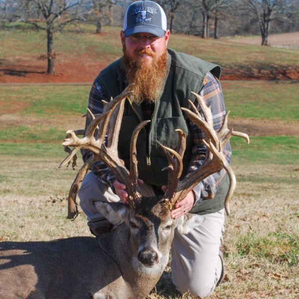 Hunter holding trophy whitetail buck deer